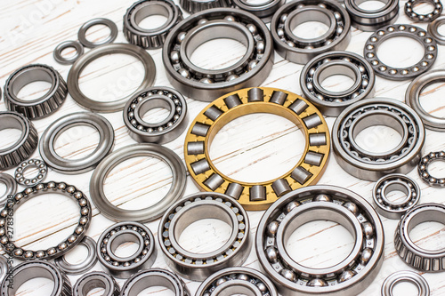 Bearings of all kinds and classifications on a white wooden background.