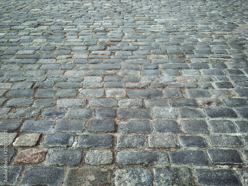 Quadro em tela Gray granite paving stones close-up. The texture of the stone.