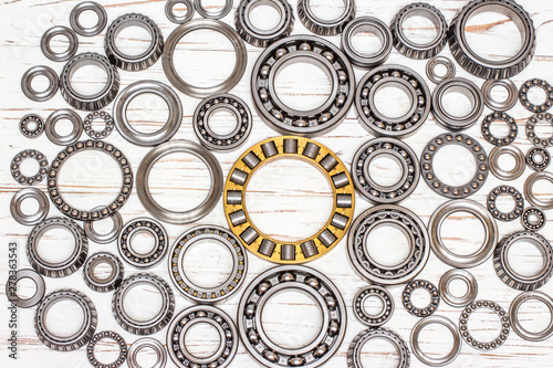 Bearings of all kinds and classifications on a white wooden background.