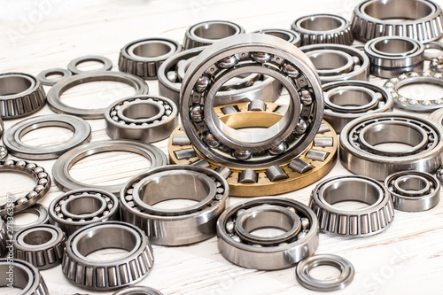Bearings of all kinds and classifications on a white wooden background.