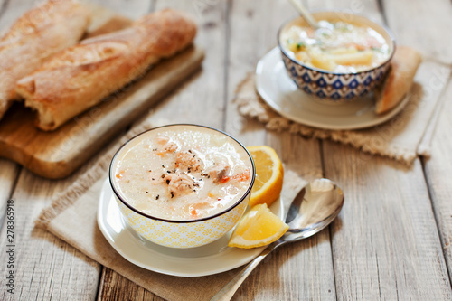 Finnish fish Soup with salmon, cream and potatoes in a bowl traditional soup in Nordic countries