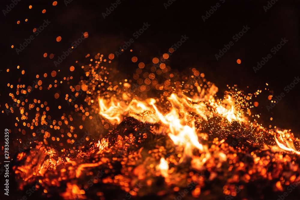 Burning red hot sparks fly from big fire. Beautiful abstract background on  the theme of fire. Burning coals, flaming particles flying off against  black background. Stock Photo | Adobe Stock