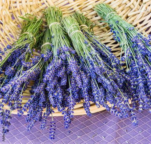 a basket of purple bunches of lavender for sale at a farmers market