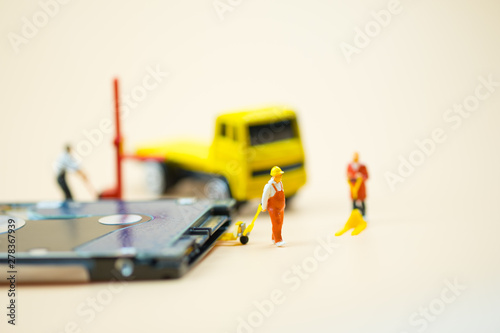 Miniature people: Workers pulling a pallet truck with circuit board moving for sent to repair. photo