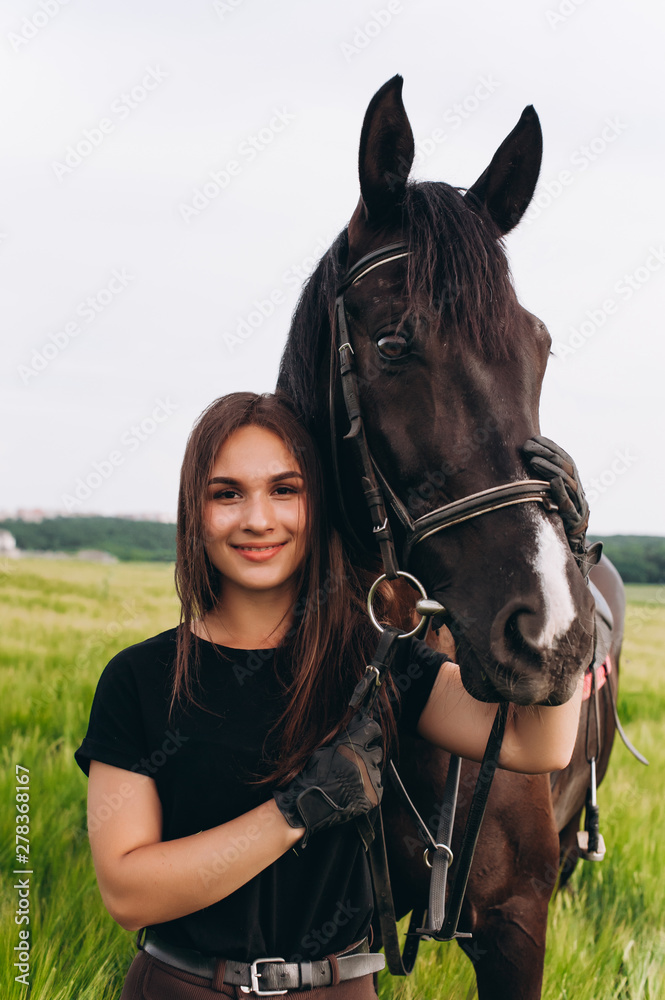 Obraz premium A girl and a young sports horse in the nature