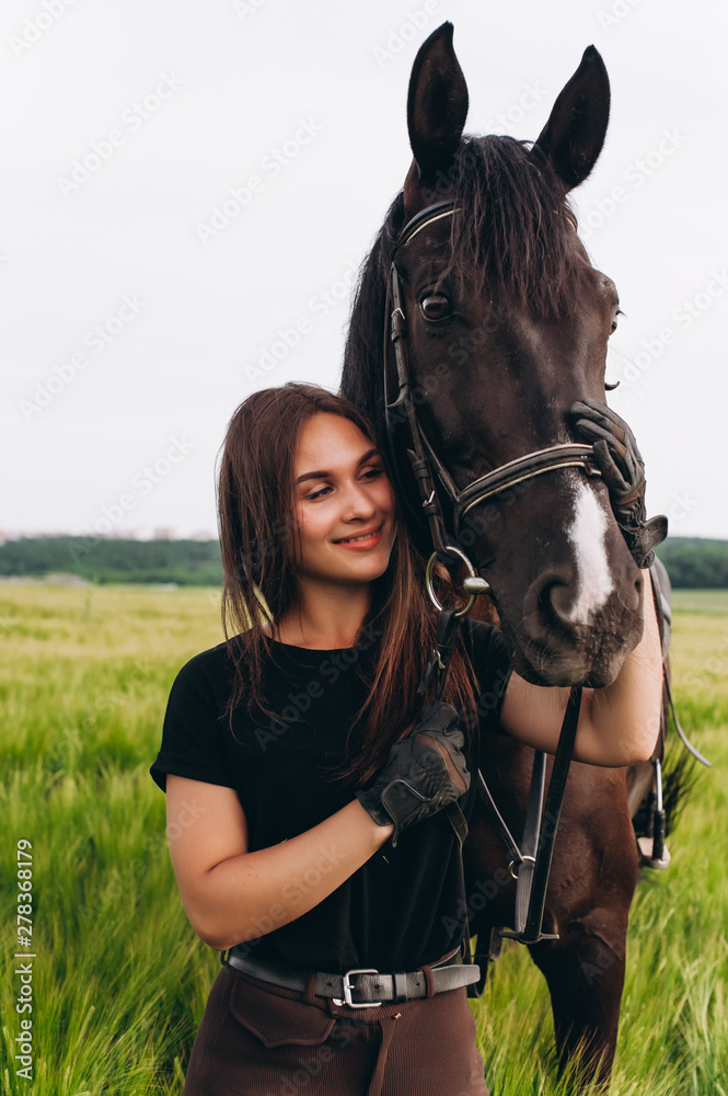 Obraz premium A girl and a young sports horse in the nature