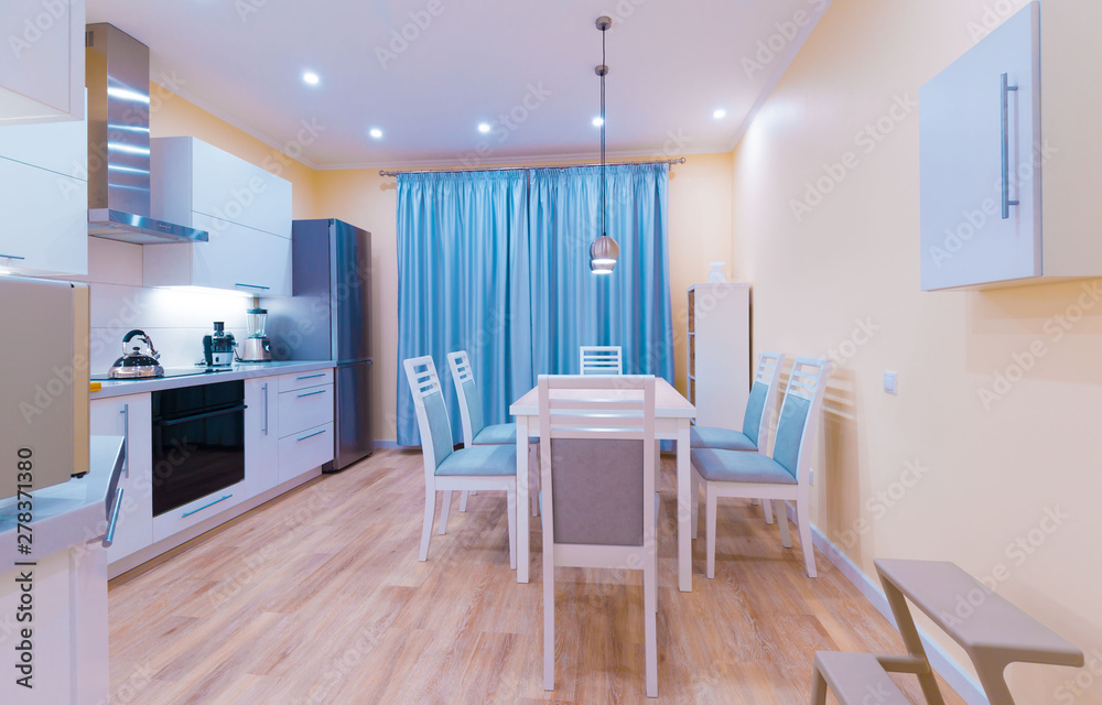 Fototapeta premium Interior. Kitchen modern, light yellow walls, blue curtains