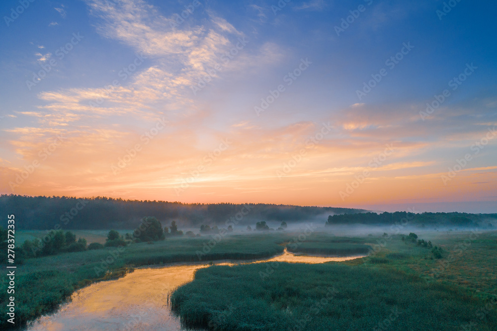 Magical sunset over the countryside. Rural landscape in the evening. Aerial view