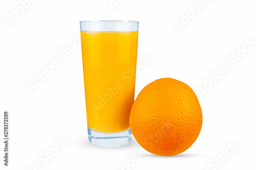The orange lies next to a glass that pours orange juice.