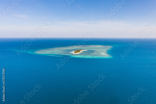 Tropical island Canimeran with sandy beach in the blue sea with coral reef, top view. Balabac, Palawan, Philippines. Small island with palm trees and white sand. © Tatiana Nurieva