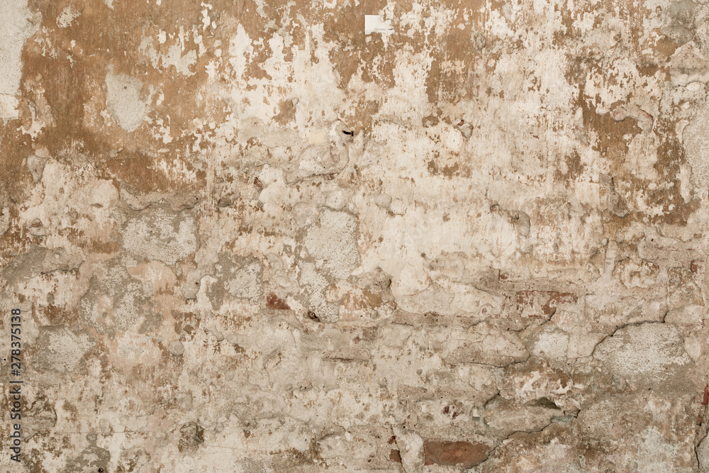 old shabby damaged plaster on the walls of houses close-up