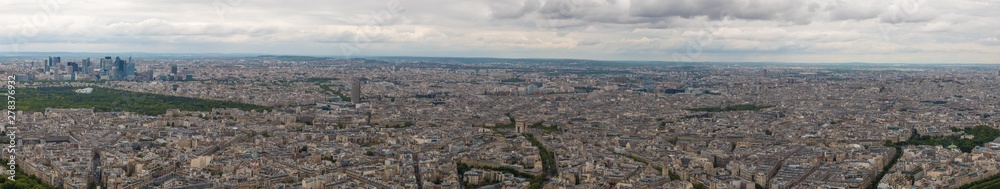 Huge aerial panorama photo of the 16th & 17th arrondissement of Paris with Arc de Triomphe in the centre. On the left side the Bois de Boulogne park and the business district La Défense can be seen.