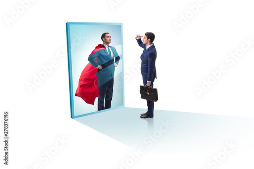 Businessman seeing himself in mirror as superhero © Elnur