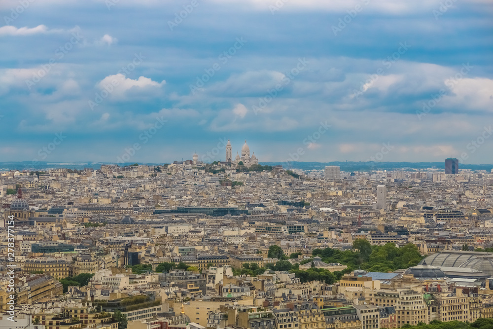 Nice aerial panoramic cityscape view with the butte Montmartre, the highest point in Paris and on the summit stands the famous white-domed Sacré-Cœur, a Roman Catholic church and minor basilica.