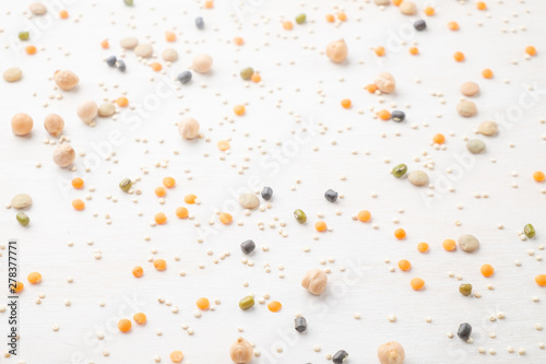 Scattered legumes on white wooden background