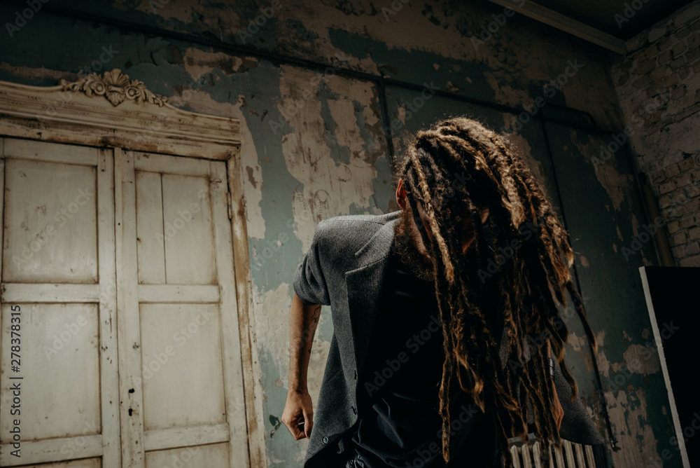 Fusion and emotion. Young man with dreadlocks, portrait