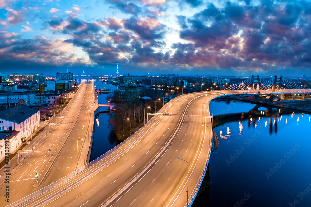 Obraz premium Saint Petersburg. Russia. Betancourt bridge. Petersburg expressway in the evening panorama. Illuminated speed highway. Petersburg transport interchanges. Neva River. Cities of Russia.