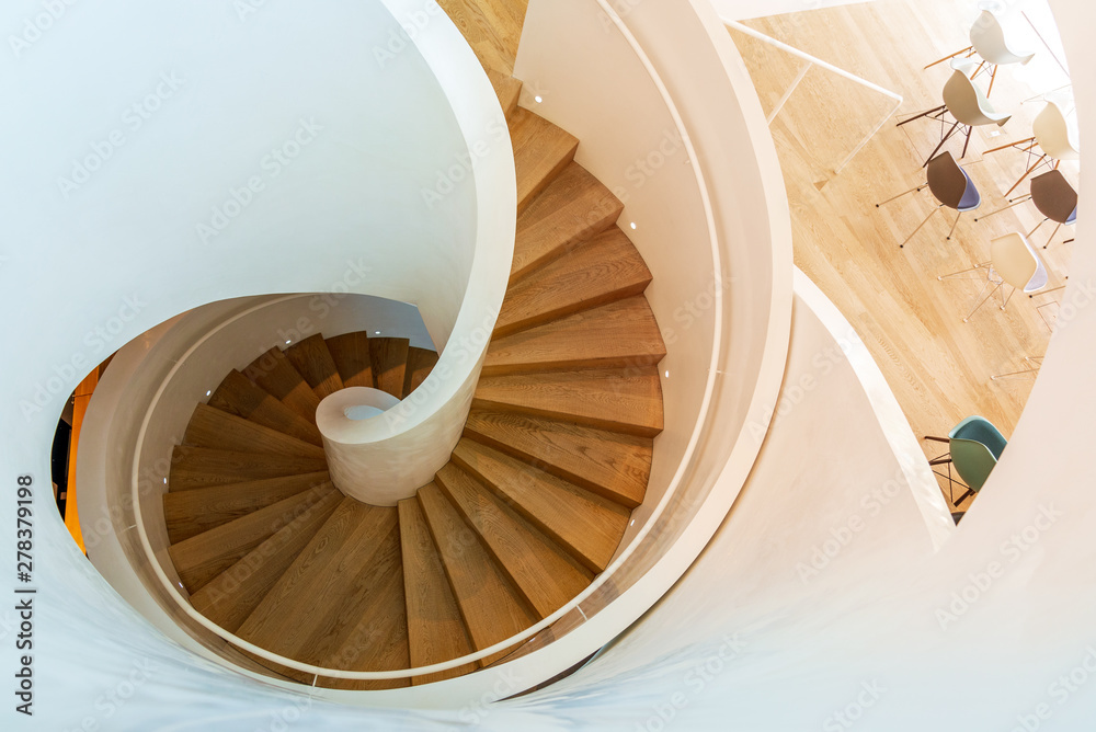 det er nytteløst Arv forhandler Top view beautiful spiral staircase consist of wooden tread and riser,  white bold railing, balustrade and round handrail, interior of furniture  showroom with. iconic spiral stairway. Stock Photo | Adobe Stock