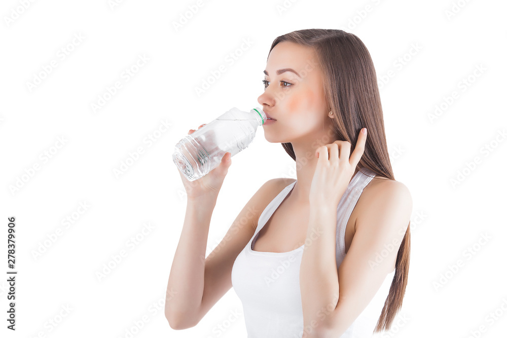 Young healthy woman drinking clean water. Female holding a bottle of water on isolated white background. Young healthy woman drinking clean water. Female holding a bottle of water on isolated white background.