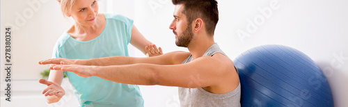 Panoramic view of handsome young man during kinesiotherapy after car accident © Photographee.eu