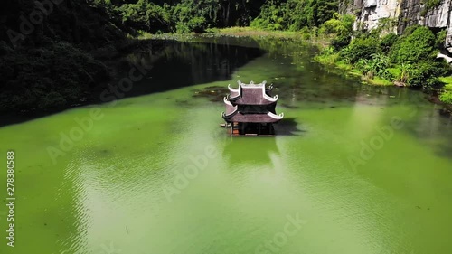 Aerial Drone Flying Above Pagoda Building Green Lake Ninh Binh, Trang An Vietnam photo