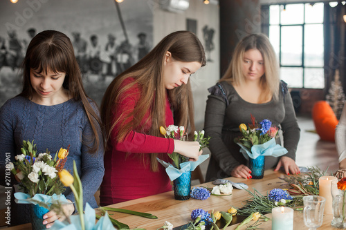 Floral maser-class. Women making a floral composition with fresh flowers. photo