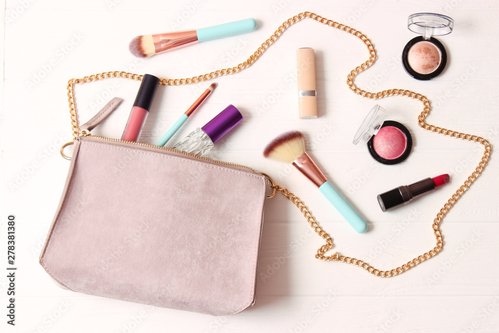 women's bag and cosmetics on a colored background women's bag and cosmetics on a colored background