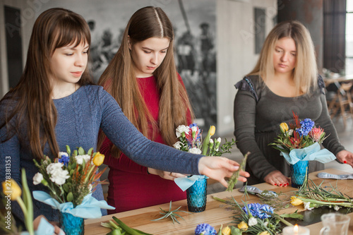 Floral maser-class. Women making a floral composition with fresh flowers. photo
