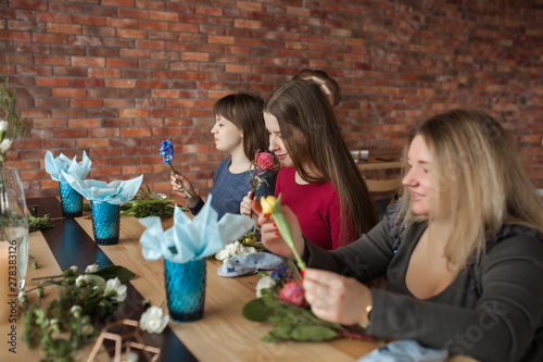 Floral maser-class. Women making a floral composition with fresh flowers. photo