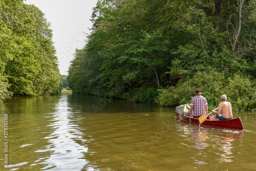 People rowing in a canoe on the river at Vestbirk, Denmark