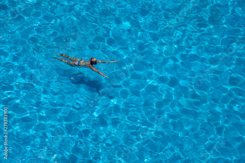 Woman swims in the pool. Summer and vacation concept