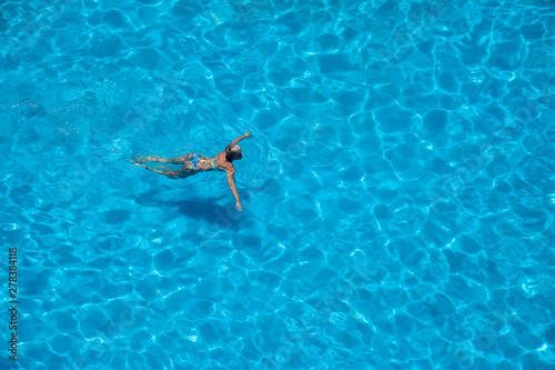Woman swims in the pool. Summer and vacation concept © Aleksej