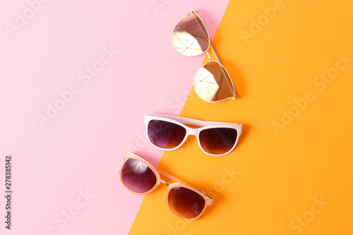 set of sunglasses on a colored background top view.