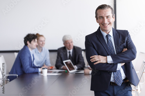 Businessman in front of his team