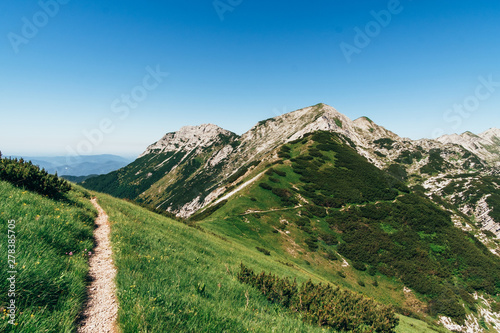 Path in the Julian Alps with mountain Vogel in the background, Slovenia, Europe.