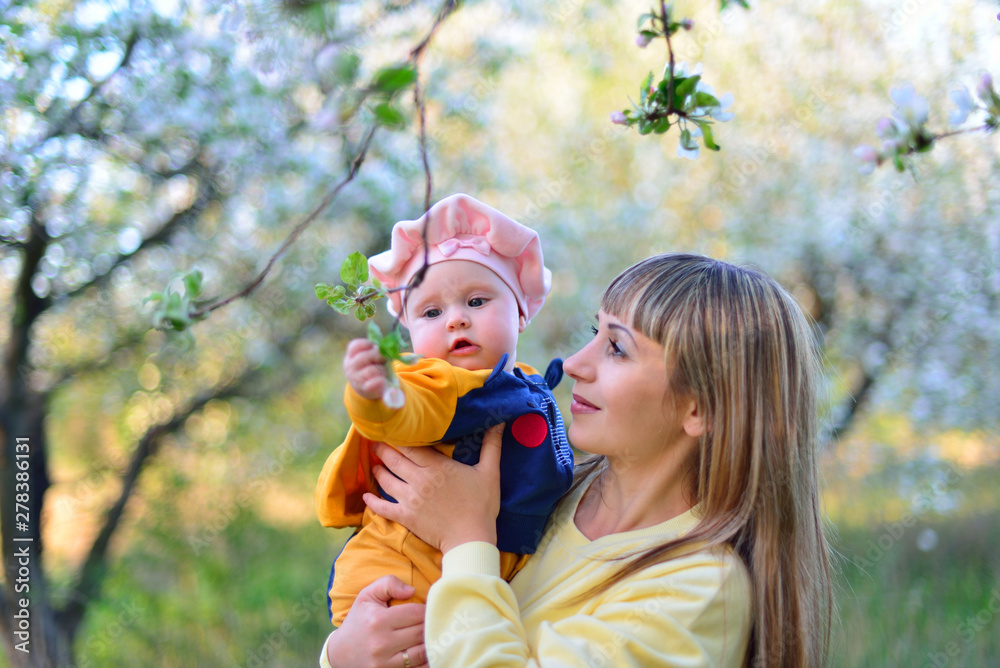 Mom and daughter in a blooming garden Mom and daughter in a blooming garden