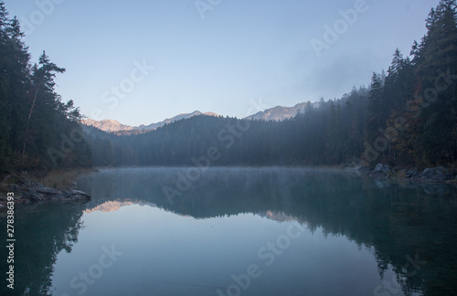 Reflections of the sunrise at the Eibsee