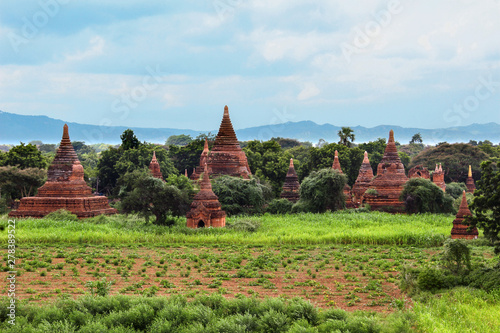 Old round buddhist temples between trees in Myanmar/Birma.