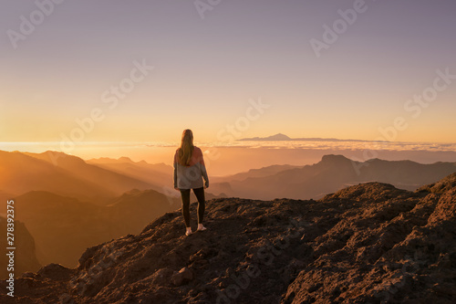 Happy young woman standing and enjoying life at sunset in mountains - gran canaria  spain