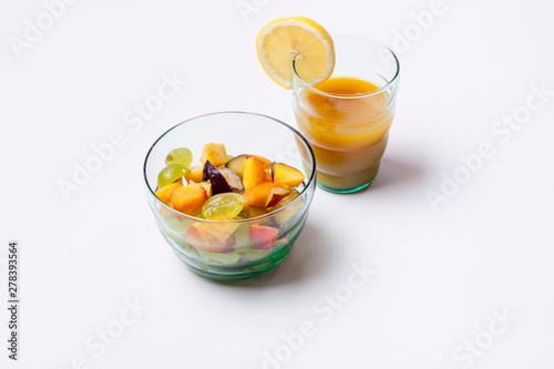 Fruit salad and orange juice isolated on white background.