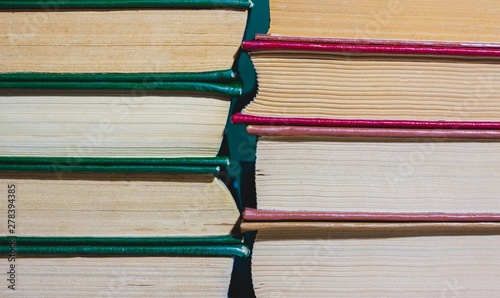 two stacks of books  with red and green covers