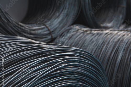 Pile of iron  metal wire rod or coil background for Construction industry. steel wire fence rolls. Steel wire tie rolls for construction and industrial. Coil of iron or steel background.