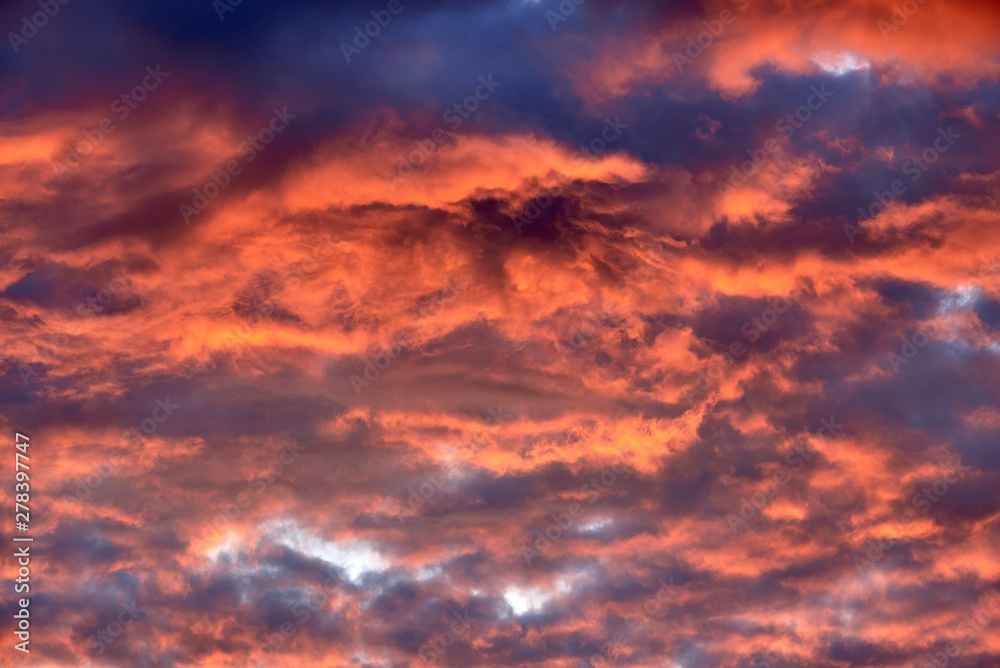 Red clouds at sunset, fire on black background