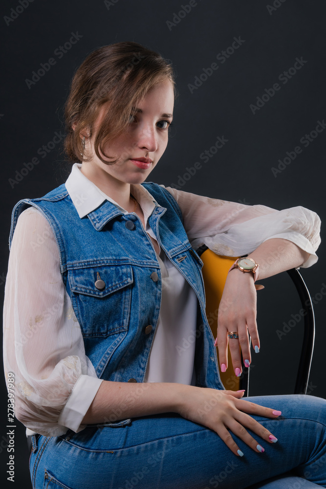 Portrait of a delightful business girl sitting on a chair
