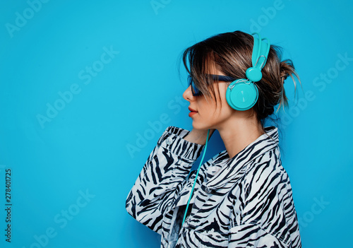 Young woman in zebra clothes and headphones