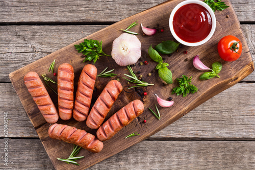 Fried sausages with herbs , spices and ketchup