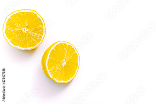 lemon cut in two with a white background