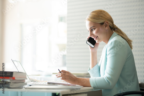 Smiling businesswoman or student looking through online information