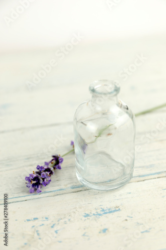 Lavender flower on shaby white wooden table with botle. minimal concept of home comfort with lavender.  photo