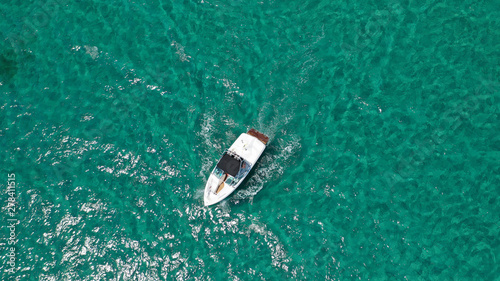 Aerial bird's eye view of inflatable rib boat cruising in high speed in turquoise clear water sea © aerial-drone